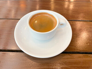 A cup of espresso coffee on a wooden table
