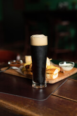 Fototapeta na wymiar Still life of Glass of stout beer on pub table