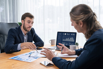 Busy analyst team in office analyzing financial data analysis for marketing strategy in workspace...