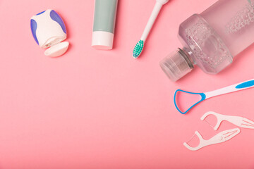 Toothbrush and tube of toothpaste on a pink background with copy space. Flat lay. Oral hygiene....