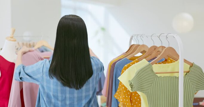 asia female choose clothes boutique