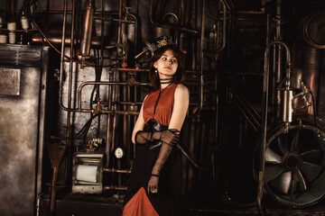 Fototapeta na wymiar Stylish teen girl model in steampunk image in retro brown dress and top hat looking away. Classy teenage girl actress 15-16 year old in industrial room. Fashionable style concept. Copy ad text space