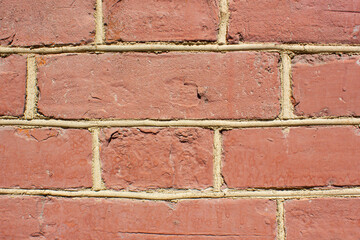 Vintage red brick wall.Dilapidated brick wall,background,texture. Faded ancient brick building.