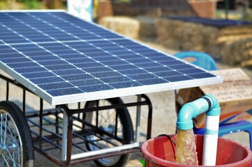 Water pumps and moveable solar panels. Groundwater is pumped with a submersible pump from clean energy or solar energy converted to electric energy on a small agricultural farm.