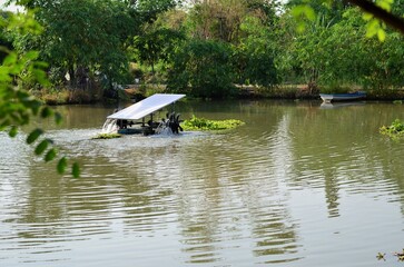 A far view of Water turbine for increasing oxygen in the water pool aquaculture. It spins by solar energy - electric sunlight automatic - clean energy technology industry to save the world