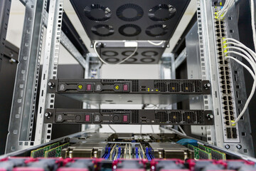 Rackmount chassis with installed servers hardware in datacenter, front view from the control panel units. Selective focus.