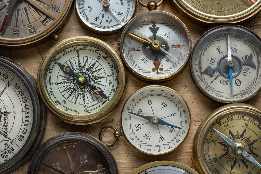 Poster collection, set of old compasses on the table. travel, geography, navigation, tourism, histoory and 