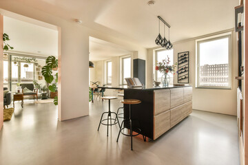 a kitchen and dining area in a house with an open door leading to the living room on the other side