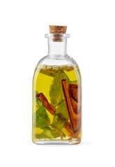 Glass bottle of cooking oil with spices and herbs isolated on white
