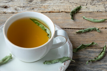 cup of green tea on wooden table
