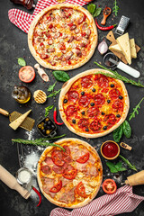 Set Pizza background. various kinds of Italian pizza on a dark background, Fast food lunch, vertical image. top view. place for text - obrazy, fototapety, plakaty