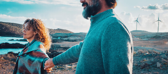 Travel lifestyle couple enjoy sunset together holding hands and looking in front. Love and...