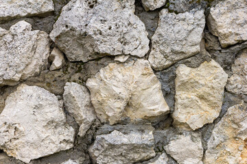 the wall is made of natural material, stone is a limestone material of volcanic origin used for...