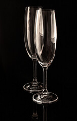 two empty wine glasses on a dark background