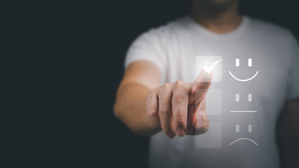 Customer service and Satisfaction concept ,Business people are touching the virtual screen on the happy Smiley face icon to give satisfaction in service. rating very impressed