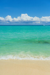 Waves with foam on the Caribbean coast in Mexico.