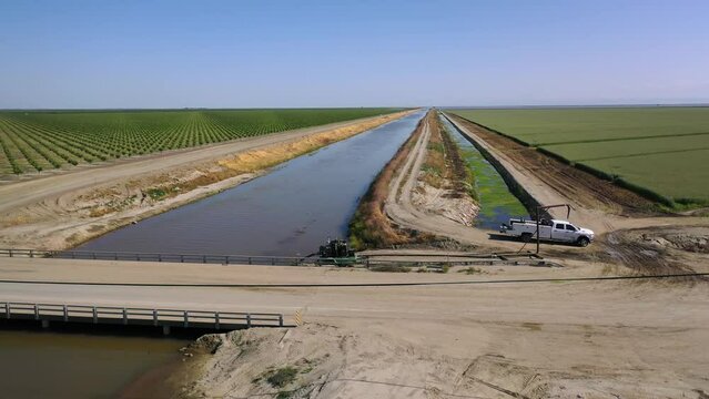 2023 - Excellent aerial view moving over the Tulare Lake Cross Creek levee, with birds flying around, in Corcoran, California.