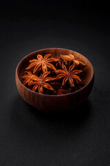 Star shaped spice star anise in a wooden round bowl