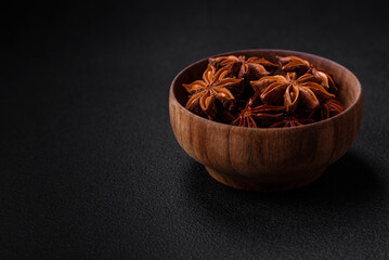 Star shaped spice star anise in a wooden round bowl