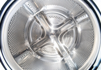 Inside of washing machine. Rotating inner tub. Material metal. Close-up of electrical household appliance.
