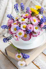 Obraz na płótnie Canvas Bouquet of daisy with pink flowers in a ceramic white mug, wooden background. Romantic still life, summer or spring inspiration, cozy home decor. Greeting card for birthday, anniversary, Mother's Day