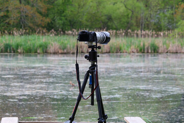 Camera on tripod shooting with point of the focus on rear of the camera. Lexington, MA, USA