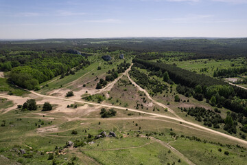 Fototapeta premium view of field with sand tracks of cars