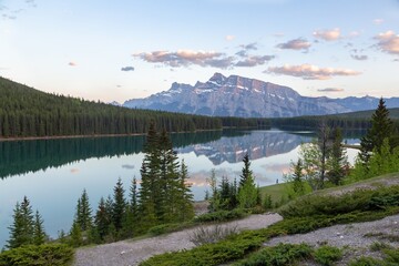 Rundle Mountain Peak Reflected in Calm Water of Two Jack Lake.  Scenic Early Morning Canadian Rocky...