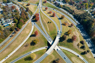 Aerial view of american freeway intersection with fast moving cars and trucks. USA transportation infrastructure concept