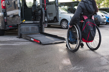 Naklejka na ściany i meble Transport for person with disability on wheelchair with van lift.
