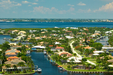 Aerial view of residential suburbs with private homes located on gulf coast near wildlife wetlands...