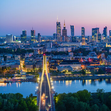 Warsaw city center, Vistula river and Swietokrzyski bridge at dusk, moody aerial landscape
