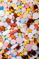 Background with the many colorful different capsules and pills. The concept of medical treatment