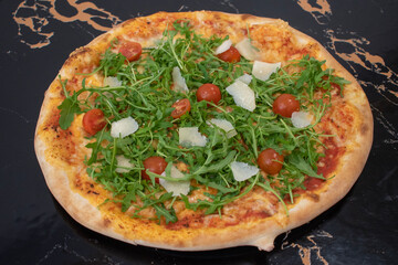 beautiful closeup pizza image and mozzarella, fresh tomatoes, arugula, grana. austria, vienna - 25 April 2023:
