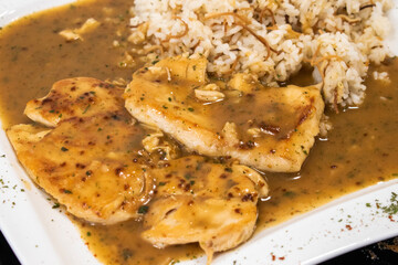 chicken cutlet with sauce and rice. delicious austrian natural schnitzel. austria, vienna - 25 April 2023