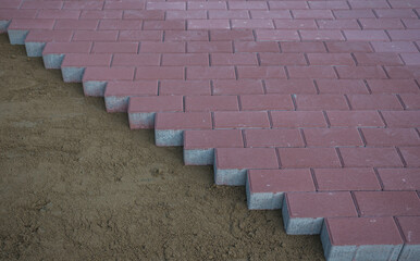 The process of building and repairing a sidewalk paved with brick, a half-built sidewalk road. Sidewalk construction.