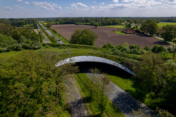 Aerial Dutch countryside road traversed by wildlife crossing forming a safe natural corridor bridge...