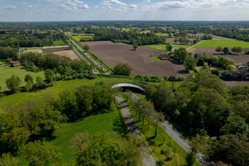 Dutch landscape with road traversed by wildlife crossing forming a safe natural corridor bridge for...