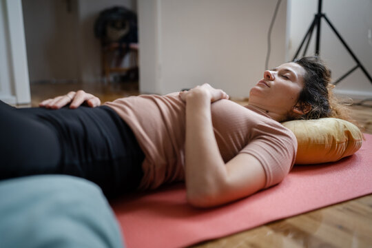 One Woman Doing Guided Meditation Yoga Self Care Practice At Home