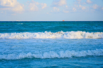 Waves with foam on the Caribbean coast in Mexico.