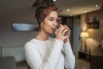 portrait of woman young caucasian female drink glass of water at home