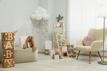 Baby shower party. Festive decor, gift boxes and toys in stylish room