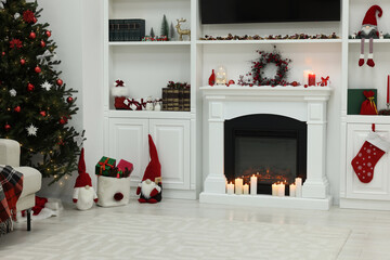Cosy room with fireplace and burning candles. Christmas atmosphere