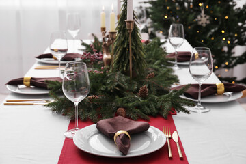 Beautiful table setting with Christmas decor indoors