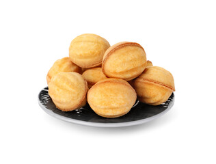 Plate of delicious nut shaped cookies with condensed milk on white background
