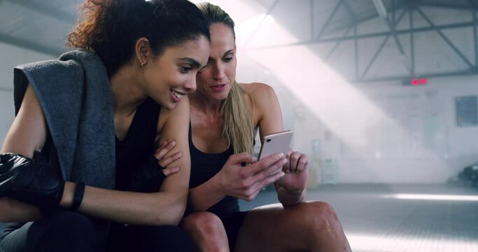Relax, phone and friends with women in gym for social media, internet and website. Training, workout and exercise with people browsing online in fitness center for mobile, communication and contact