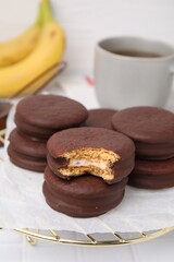Tasty banana choco pies on white table, closeup