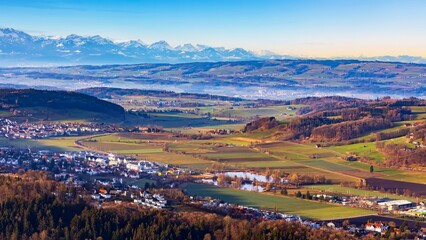 Beautiful panorama landscape of Swiss Alps mountain from Uetliberg,Switzerland.Top summit of Zurich in winter season.Tourist destination for travel.Sunrise with blue sky and snow cap mountain.