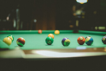 pool and billiards being played in bar