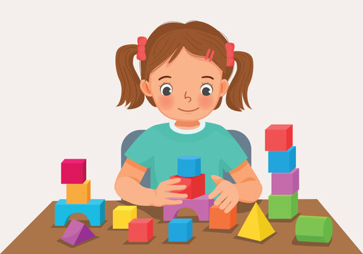 Cute little girl playing colorful wooden brick block toys at the table